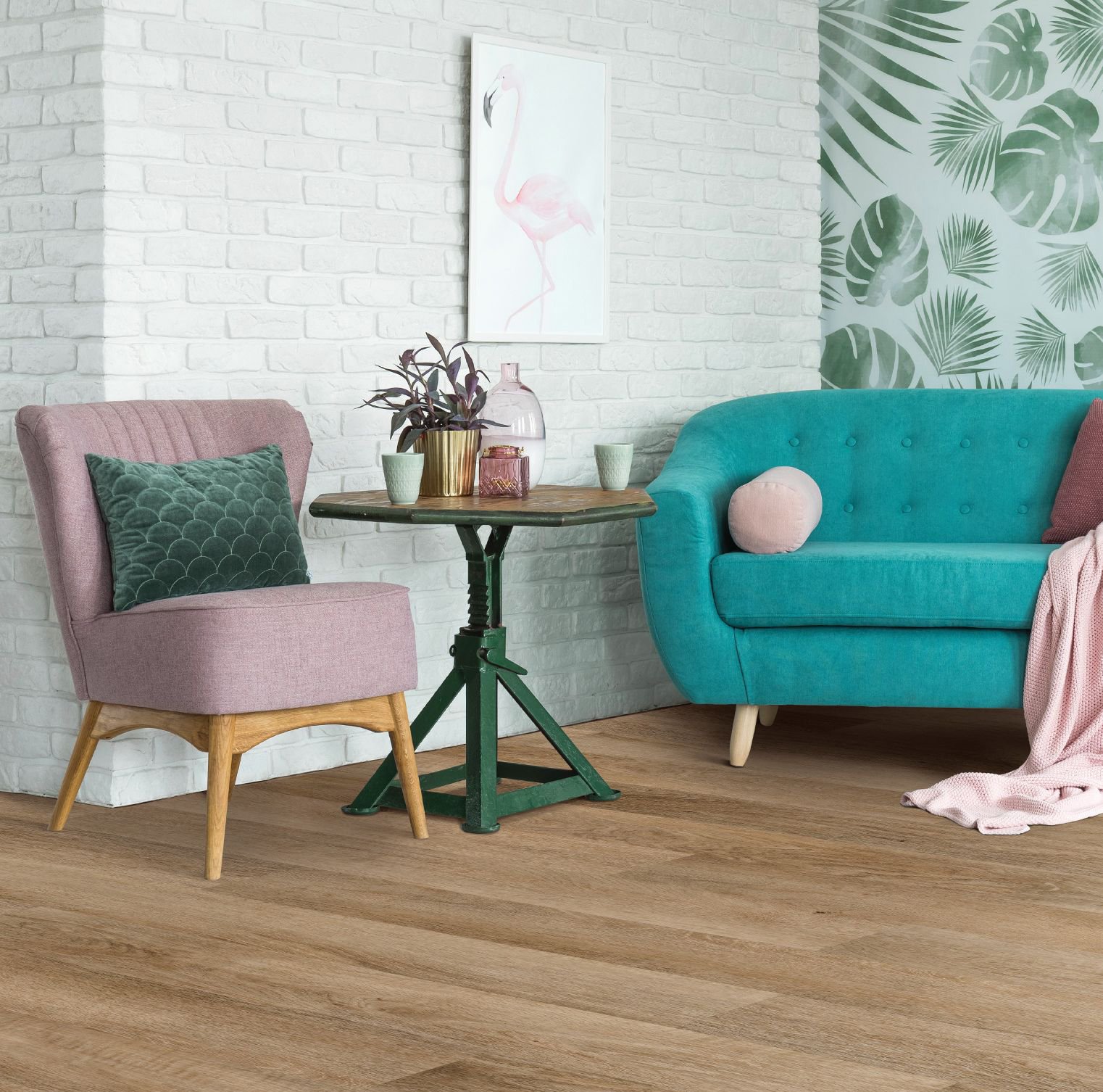 pink arm chair and teal couch on wood look flooring - B D Flooring Inc